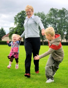 grandmother and her two grandchildren running together