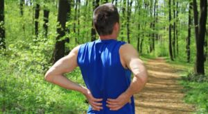 Man Trail Running With Back Pain