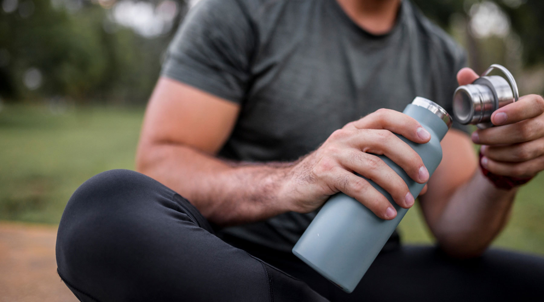 Man with water bottle, depicting the importance of hydration during exercise.