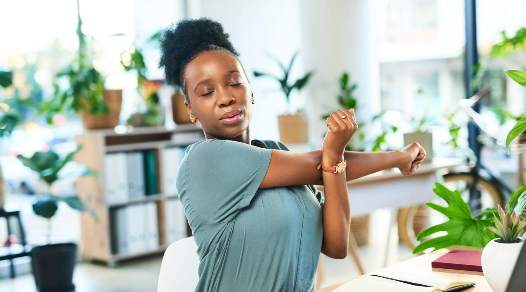 Woman doing some arm stretching at the office